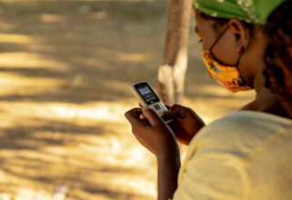 A young woman saves helpline numbers on her cell phone in Mozambique. Photo: UNFPA Mozambique / Mbuto Machili